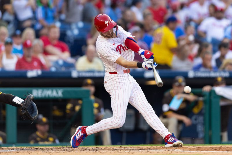 Jun 18, 2024; Philadelphia, Pennsylvania, USA; Philadelphia Phillies shortstop Trea Turner (7) hits a single during the third inning against the San Diego Padres at Citizens Bank Park. Mandatory Credit: Bill Streicher-USA TODAY Sports