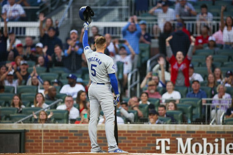 Sep 13, 2024; Atlanta, Georgia, USA; Los Angeles Dodgers first baseman Freddie Freeman (5) acknowledges the crowd before an at bat against the Atlanta Braves in the first inning at Truist Park. Mandatory Credit: Brett Davis-Imagn Images