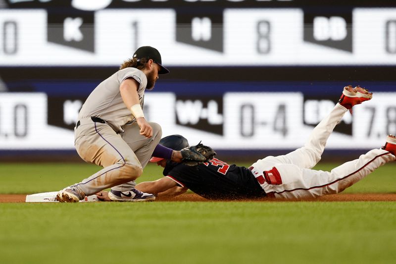 Aug 21, 2024; Washington, District of Columbia, USA; Washington Nationals outfielder Jacob Young (30) steals second base ahead of a tag by Colorado Rockies second baseman Brendan Rodgers (7) during the fifth inning at Nationals Park. Mandatory Credit: Geoff Burke-USA TODAY Sports