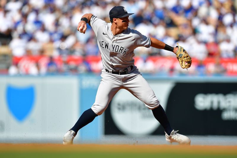 Jun 4, 2023; Los Angeles, California, USA; New York Yankees shortstop Anthony Volpe (11) throws to first for the out against Los Angeles Dodgers catcher Will Smith (16) during the first inning at Dodger Stadium. Mandatory Credit: Gary A. Vasquez-USA TODAY Sports