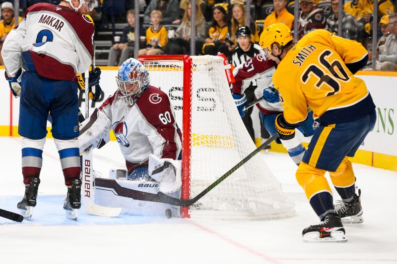 Nov 2, 2024; Nashville, Tennessee, USA;  Colorado Avalanche goaltender Justus Annunen (60) blocks the shot of Nashville Predators left wing Cole Smith (36) during the third period at Bridgestone Arena. Mandatory Credit: Steve Roberts-Imagn Images