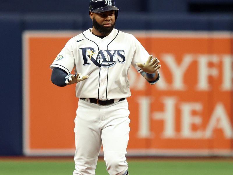 Sep 21, 2023; St. Petersburg, Florida, USA; Tampa Bay Rays center fielder Manuel Margot (13) hits a RBI double during the sixth inning against the Los Angeles Angels at Tropicana Field. Mandatory Credit: Kim Klement Neitzel-USA TODAY Sports