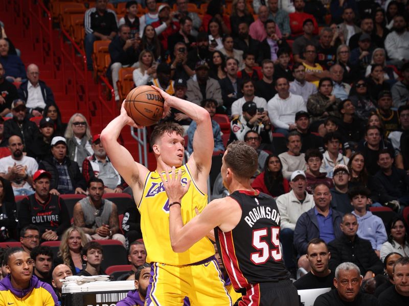 MIAMI, FL - DECEMBER 4: Dalton Knecht #4 of the Los Angeles Lakers handles the ball during the game against the Miami Heat on December 4, 2024 at Kaseya Center in Miami, Florida. NOTE TO USER: User expressly acknowledges and agrees that, by downloading and or using this Photograph, user is consenting to the terms and conditions of the Getty Images License Agreement. Mandatory Copyright Notice: Copyright 2024 NBAE (Photo by Joe Murphy/NBAE via Getty Images)