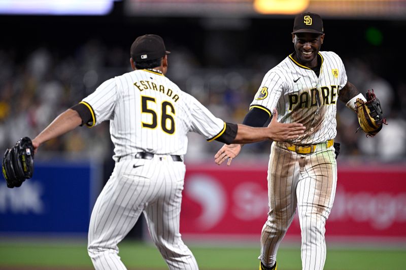 Sep 21, 2024; San Diego, California, USA; San Diego Padres left fielder Jurickson Profar (right) celebrates with relief pitcher Jeremiah Estrada (56) after a diving catch to end the top of the seventh inning against the Chicago White Sox at Petco Park. Mandatory Credit: Orlando Ramirez-Imagn Images