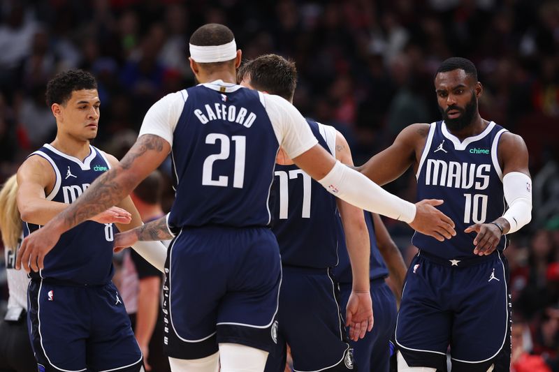 CHICAGO, ILLINOIS - MARCH 11: Daniel Gafford #21 of the Dallas Mavericks high fives Josh Green #8 and Tim Hardaway Jr. #10 against the Chicago Bulls during the second half at the United Center on March 11, 2024 in Chicago, Illinois. NOTE TO USER: User expressly acknowledges and agrees that, by downloading and or using this photograph, User is consenting to the terms and conditions of the Getty Images License Agreement.  (Photo by Michael Reaves/Getty Images)