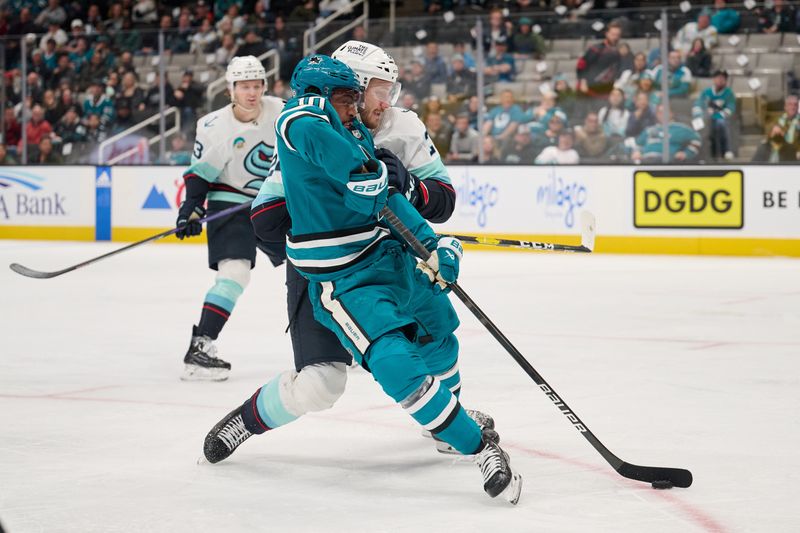 Jan 30, 2024; San Jose, California, USA; Seattle Kraken defenseman Jamie Oleksiak (24) defends against San Jose Sharks left wing Anthony Duclair (10) during the second period at SAP Center at San Jose. Mandatory Credit: Robert Edwards-USA TODAY Sports