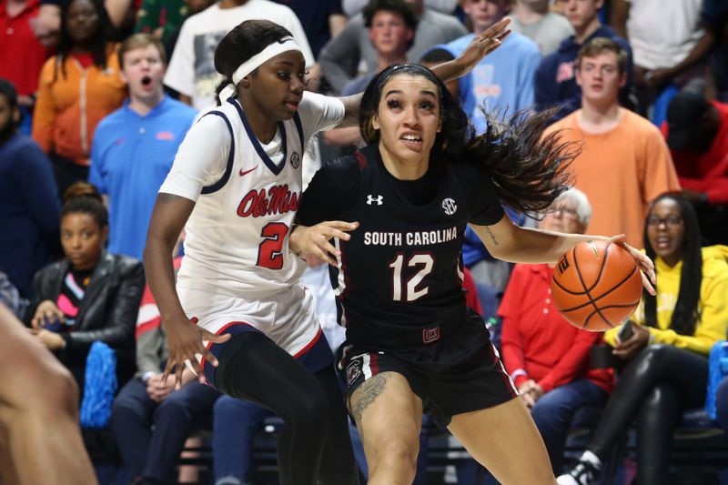 Feb 19, 2023; Oxford, Mississippi, USA; South Carolina Gamecocks guard Brea Beal (12) drives to the basket as Mississippi Rebels guard Marquesha Davis (2) defends during overtime at The Sandy and John Black Pavilion at Ole Miss. Mandatory Credit: Petre Thomas-USA TODAY Sports