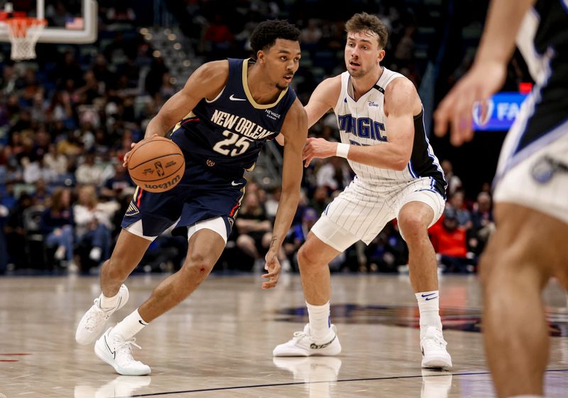 NEW ORLEANS, LOUISIANA - MARCH 13: Trey Murphy III #25 of the New Orleans Pelicans drives past Franz Wagner #22 of the Orlando Magic during the second half of a game at the Smoothie King Center on March 13, 2025 in New Orleans, Louisiana. NOTE TO USER: User expressly acknowledges and agrees that, by downloading and or using this photograph, User is consenting to the terms and conditions of the Getty Images License Agreement. (Photo by Derick E. Hingle/Getty Images)