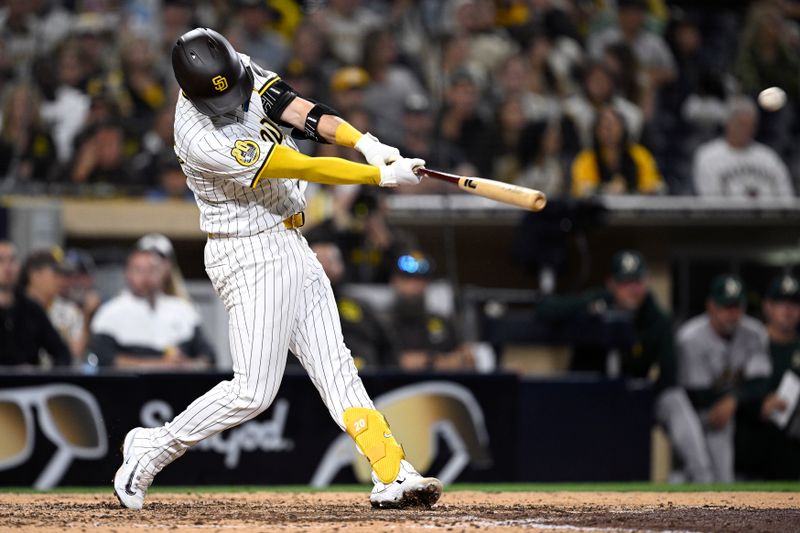 Jun 11, 2024; San Diego, California, USA; San Diego Padres catcher Kyle Higashioka (20) hits a walk-off home run during the ninth inning against the Oakland Athletics at Petco Park. Mandatory Credit: Orlando Ramirez-USA TODAY Sports