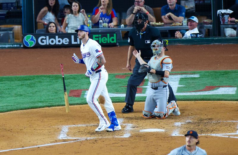 Jun 5, 2024; Arlington, Texas, USA;  Texas Rangers catcher Jonah Heim (28) hits a two-run home run during the third inning against the Detroit Tigers at Globe Life Field. Mandatory Credit: Kevin Jairaj-USA TODAY Sports