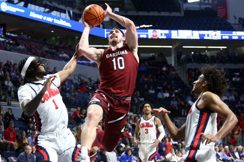 Feb 11, 2023; Oxford, Mississippi, USA; South Carolina Gamecocks forward Hayden Brown (10) drives to the basket as Mississippi Rebels guard Amaree Abram (1) defends during the first half at The Sandy and John Black Pavilion at Ole Miss. Mandatory Credit: Petre Thomas-USA TODAY Sports