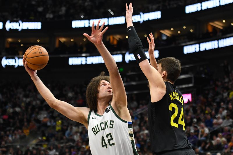 SALT LAKE CITY, UTAH - FEBRUARY 04: Robin Lopez #42 of the Milwaukee Bucks shoots over Walker Kessler #24 of the Utah Jazz during the first half at Delta Center on February 04, 2024 in Salt Lake City, Utah. NOTE TO USER: User expressly acknowledges and agrees that, by downloading and or using this photograph, User is consenting to the terms and conditions of the Getty Images License Agreement. (Photo by Alex Goodlett/Getty Images)