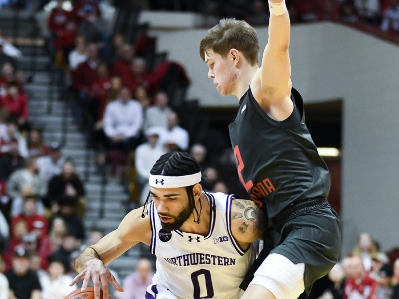 Feb 18, 2024; Bloomington, Indiana, USA;  Northwestern Wildcats guard Boo Buie (0) dribbles the ball against Indiana Hoosiers guard Gabe Cupps (2) during the second half at Simon Skjodt Assembly Hall. Mandatory Credit: Robert Goddin-USA TODAY Sports