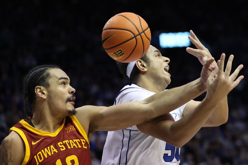 Jan 16, 2024; Provo, Utah, USA; Iowa State Cyclones forward Robert Jones (12) and Brigham Young Cougars center Aly Khalifa (50) play for a loose ball during the second half at Marriott Center. Mandatory Credit: Rob Gray-USA TODAY Sports