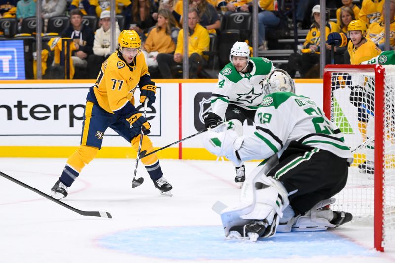 Oct 10, 2024; Nashville, Tennessee, USA;  Dallas Stars goaltender Jake Oettinger (29) blocks the shot of Nashville Predators right wing Luke Evangelista (77) during the first period at Bridgestone Arena. Mandatory Credit: Steve Roberts-Imagn Images