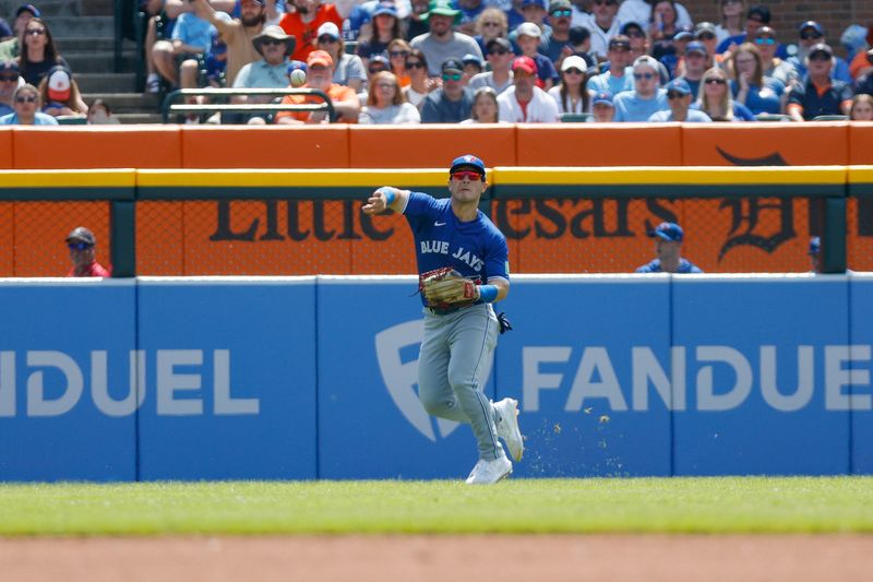 May 26, 2024; Detroit, Michigan, USA; Toronto Blue Jays outfielder Daulton Varsho (25) returns a ball in the first inning against the Detroit Tigers at Comerica Park. Mandatory Credit: Brian Bradshaw Sevald-USA TODAY Sports