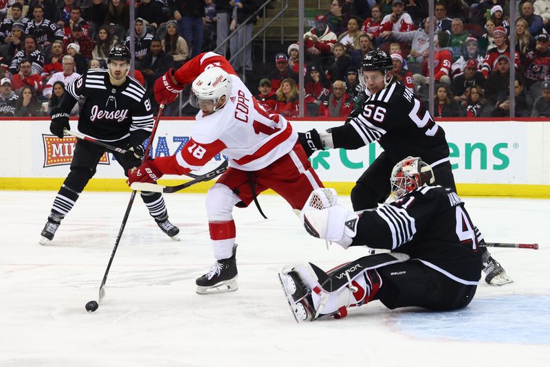 Dec 23, 2023; Newark, New Jersey, USA; New Jersey Devils left wing Erik Haula (56) hooks Detroit Red Wings center Andrew Copp (18) as he tries to shoot the puck during the third period at Prudential Center. Mandatory Credit: Ed Mulholland-USA TODAY Sports