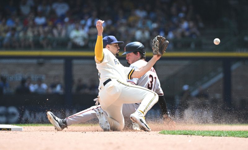 Jun 21, 2023; Milwaukee, Wisconsin, USA; Arizona Diamondbacks right fielder Jake McCarthy (31) slides in safely ahead of the tag by Milwaukee Brewers shortstop Willy Adames (27) in the fifth inning at American Family Field. Mandatory Credit: Michael McLoone-USA TODAY Sports