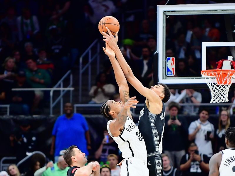 AUSTIN, TX - MARCH 17: Nicolas Claxton #33 of the Brooklyn Nets and Victor Wembanyama #1 of the San Antonio Spurs go up for a jump ball during the game on March 17, 2024 at the Moody Center in Austin, Texas. NOTE TO USER: User expressly acknowledges and agrees that, by downloading and or using this photograph, user is consenting to the terms and conditions of the Getty Images License Agreement. Mandatory Copyright Notice: Copyright 2024 NBAE (Photos by Michael Gonzales/NBAE via Getty Images)