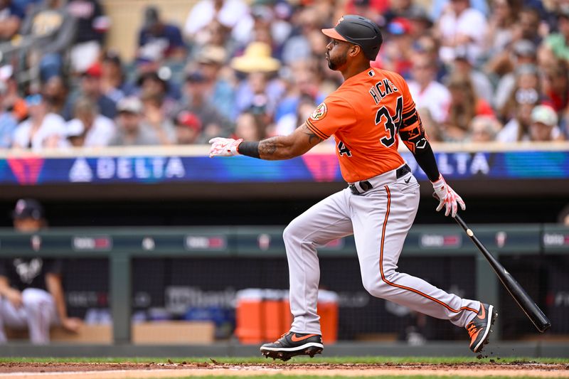 Jul 8, 2023; Minneapolis, Minnesota, USA;  Baltimore Orioles outfielder Aaron Hicks (34) hits a single against the Minnesota Twins during the second inning at Target Field. Mandatory Credit: Nick Wosika-USA TODAY Sports