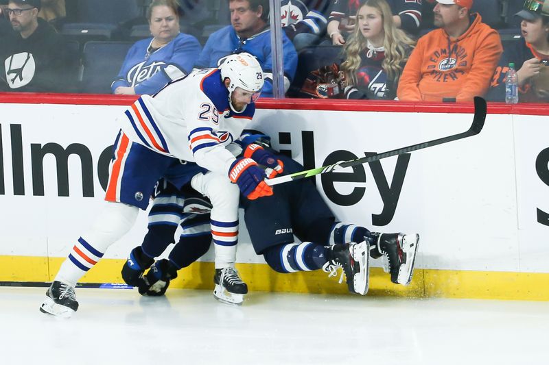 Nov 30, 2023; Winnipeg, Manitoba, CAN; Edmonton Oilers forward Leon Draisaitl (29) bodies Winnipeg Jets forward Nikolaj Ehlers (27) during the third period at Canada Life Centre. Mandatory Credit: Terrence Lee-USA TODAY Sports