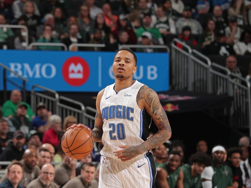 MILWAUKEE, WI - APRIL 10: Markelle Fultz #20 of the Orlando Magic brings the ball up court during the game against the Milwaukee Bucks on April 10, 2024 at the Fiserv Forum Center in Milwaukee, Wisconsin. NOTE TO USER: User expressly acknowledges and agrees that, by downloading and or using this Photograph, user is consenting to the terms and conditions of the Getty Images License Agreement. Mandatory Copyright Notice: Copyright 2024 NBAE (Photo by Gary Dineen/NBAE via Getty Images).