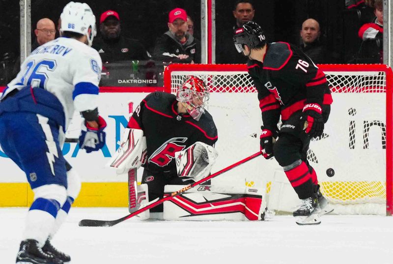 Nov 24, 2023; Raleigh, North Carolina, USA; Carolina Hurricanes goaltender Antti Raanta (32) watches Tampa Bay Lightning center Brayden Point (21) (not shown) goal during the third period at PNC Arena. Mandatory Credit: James Guillory-USA TODAY Sports