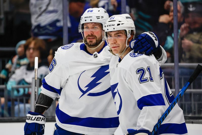 Dec 9, 2023; Seattle, Washington, USA; Tampa Bay Lightning right wing Nikita Kucherov (86) celebrates with center Brayden Point (21) after scoring a goal against the Seattle Kraken during the first period at Climate Pledge Arena. Mandatory Credit: Joe Nicholson-USA TODAY Sports