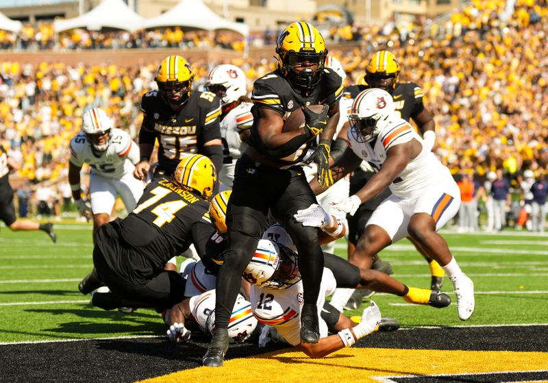 Oct 19, 2024; Columbia, Missouri, USA; Missouri Tigers running back Marcus Carroll (9) scores a touchdown during the second half against the Auburn Tigers at Faurot Field at Memorial Stadium. Mandatory Credit: Jay Biggerstaff-Imagn Images