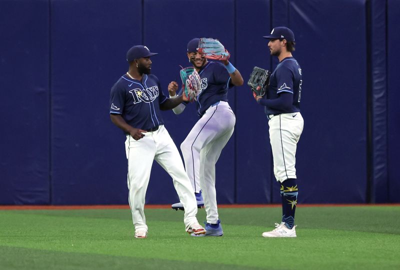 Jun 24, 2024; St. Petersburg, Florida, USA; Tampa Bay Rays outfielder Randy Arozarena (56), outfielder Jose Siri (22), and outfielder Josh Lowe (15) celebrate after they beat the Seattle Mariners at Tropicana Field. Mandatory Credit: Kim Klement Neitzel-USA TODAY Sports