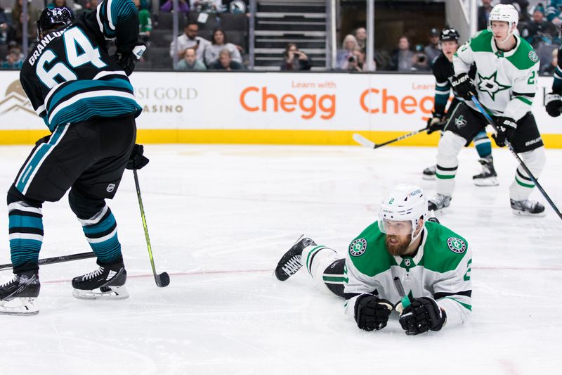 Mar 5, 2024; San Jose, California, USA; San Jose Sharks center Mikael Granlund (64) and Dallas Stars defenseman Jani Hakanpaa (2) collide during the second period at SAP Center at San Jose. Mandatory Credit: John Hefti-USA TODAY Sports