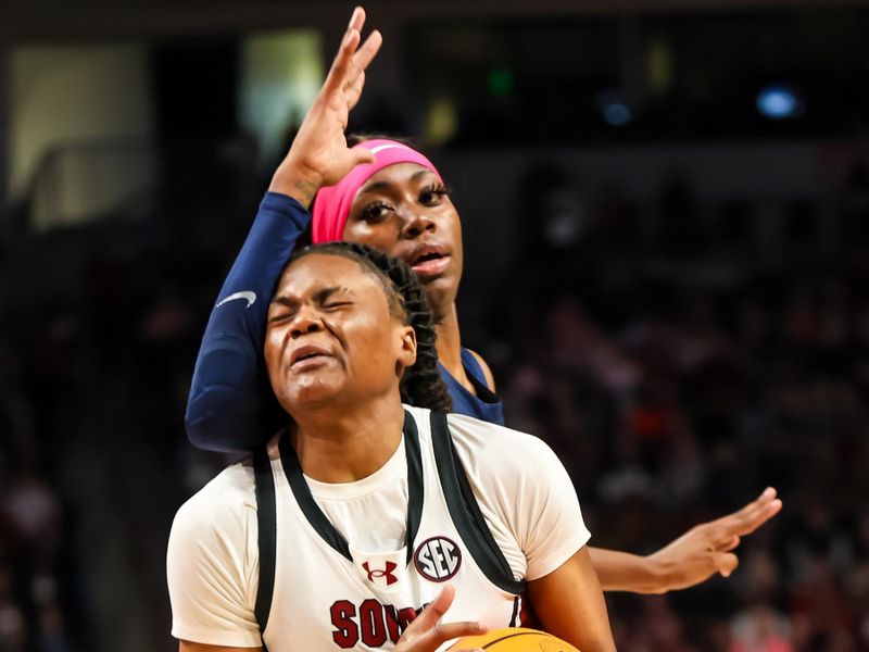 Feb 4, 2024; Columbia, South Carolina, USA; South Carolina Gamecocks guard MiLaysia Fulwiley (12) drives into Ole Miss Rebels guard Marquesha Davis (2) in the first half at Colonial Life Arena. Mandatory Credit: Jeff Blake-USA TODAY Sports