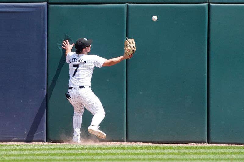 Jul 31, 2024; Chicago, Illinois, USA; Chicago White Sox outfielder Dominic Fletcher (7) cannot catch a ball hit for a double hit by Kansas City Royals catcher Salvador Perez (not pictured) during the fifth inning at Guaranteed Rate Field. Mandatory Credit: David Banks-USA TODAY Sports