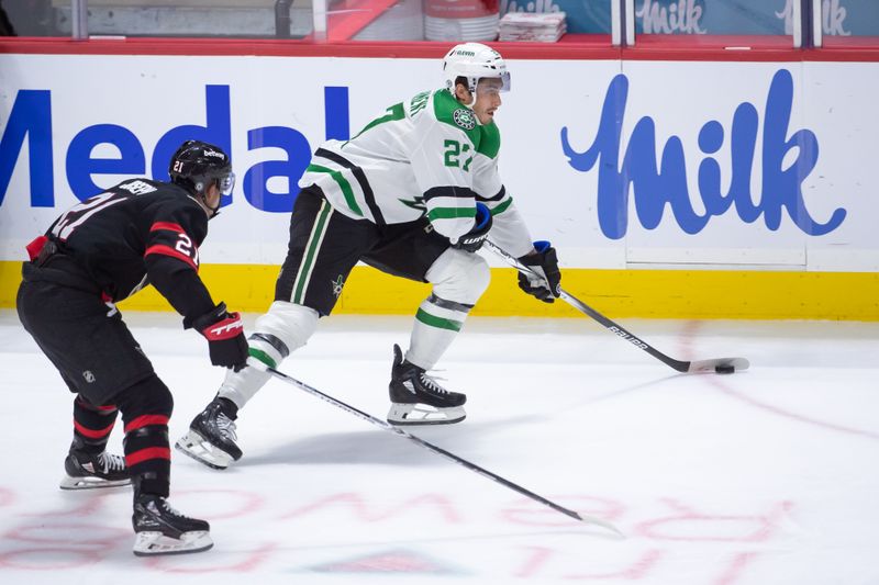 Feb 22, 2024; Ottawa, Ontario, CAN; Dallas Stars left wing Mason Marchment (27) skates with the puck in front of  Ottawa Senators right wing Mathieu Joseph (21) in the third period at the Canadian Tire Centre. Mandatory Credit: Marc DesRosiers-USA TODAY Sports