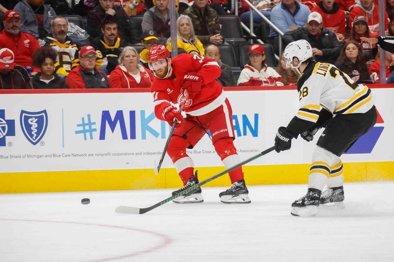 Nov 23, 2024; Detroit, Michigan, USA; Detroit Red Wings left wing J.T. Compher (37) passes the puck during the second period of the game against the Boston Bruins at Little Caesars Arena. Mandatory Credit: Brian Bradshaw Sevald-Imagn Images