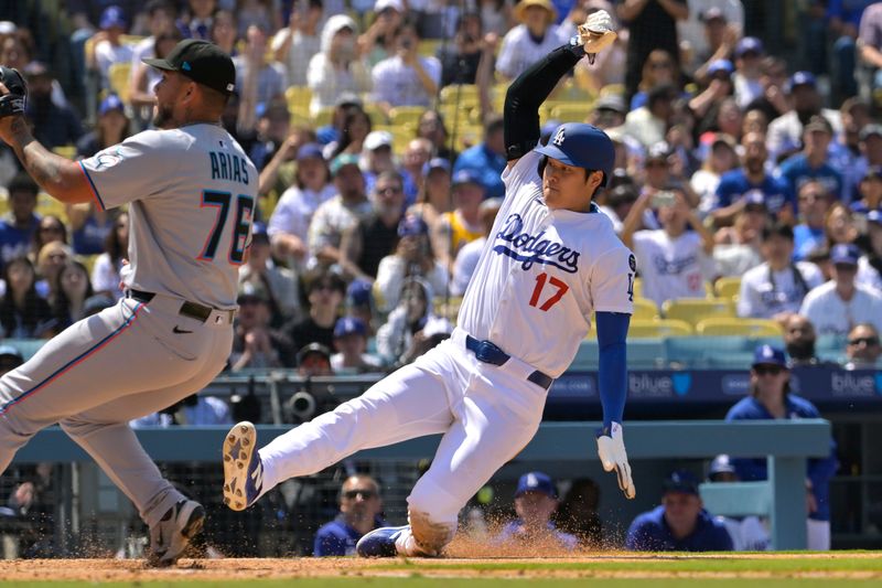 Apr 30, 2025; Los Angeles, California, USA;  Los Angeles Dodgers designated hitter Shohei Ohtani (17) beats the tag by Miami Marlins relief pitcher Luarbert Arias (76) scoring on a wild pitch in the eighth inning at Dodger Stadium. Mandatory Credit: Jayne Kamin-Oncea-Imagn Images