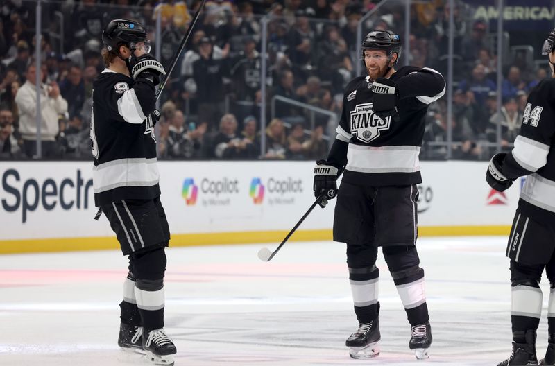 Nov 9, 2024; Los Angeles, California, USA; Los Angeles Kings defenseman Vladislav Gavrikov (84) celebrates with right wing Adrian Kempe (9) after scoring during the second period against the Columbus Blue Jackets at Crypto.com Arena. Mandatory Credit: Jason Parkhurst-Imagn Images