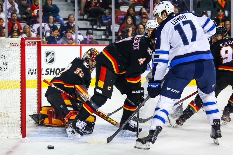 Oct 26, 2024; Calgary, Alberta, CAN; Calgary Flames goaltender Dustin Wolf (32) makes a save against Winnipeg Jets during the first period at Scotiabank Saddledome. Mandatory Credit: Sergei Belski-Imagn Images