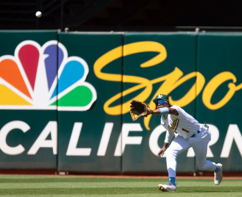 Jun 18, 2023; Oakland, California, USA; Oakland Athletics center fielder Esteury Ruiz (1) makes a running catch of a line drive by Philadelphia Phillies center fielder Brandon Marsh during the ninth inning at Oakland-Alameda County Coliseum. Mandatory Credit: D. Ross Cameron-USA TODAY Sports