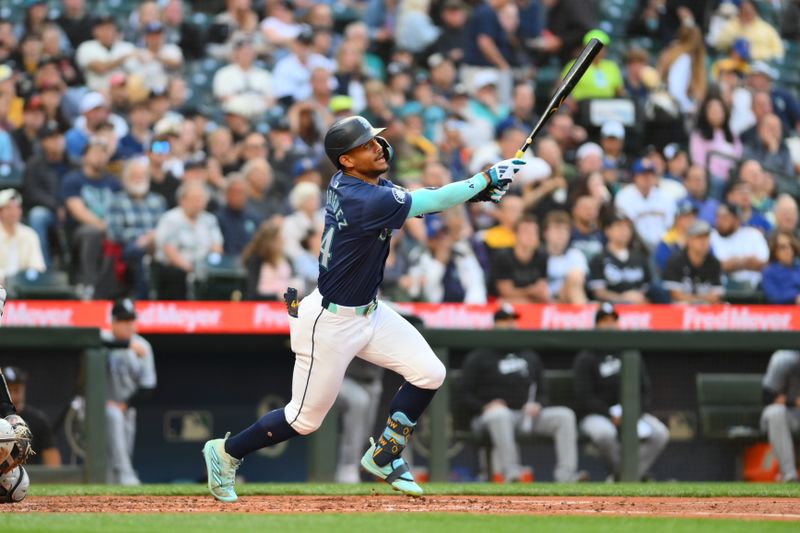 Jun 10, 2024; Seattle, Washington, USA; Seattle Mariners center fielder Julio Rodriguez (44) hits a single against the Chicago White Sox during the fourth inning at T-Mobile Park. Mandatory Credit: Steven Bisig-USA TODAY Sports