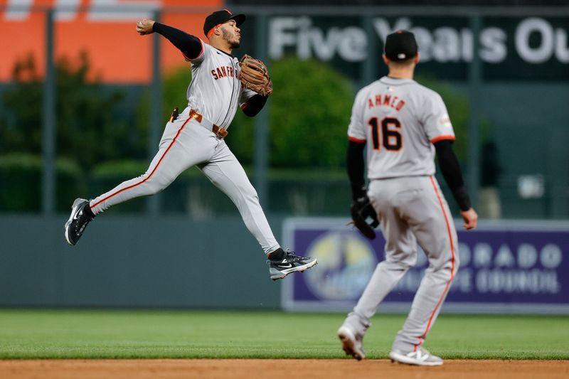 May 7, 2024; Denver, Colorado, USA; San Francisco Giants second baseman Thairo Estrada (39) makes a throw to first as shortstop Nick Ahmed (16) looks on in the ninth inning against the Colorado Rockies at Coors Field. Mandatory Credit: Isaiah J. Downing-USA TODAY Sports