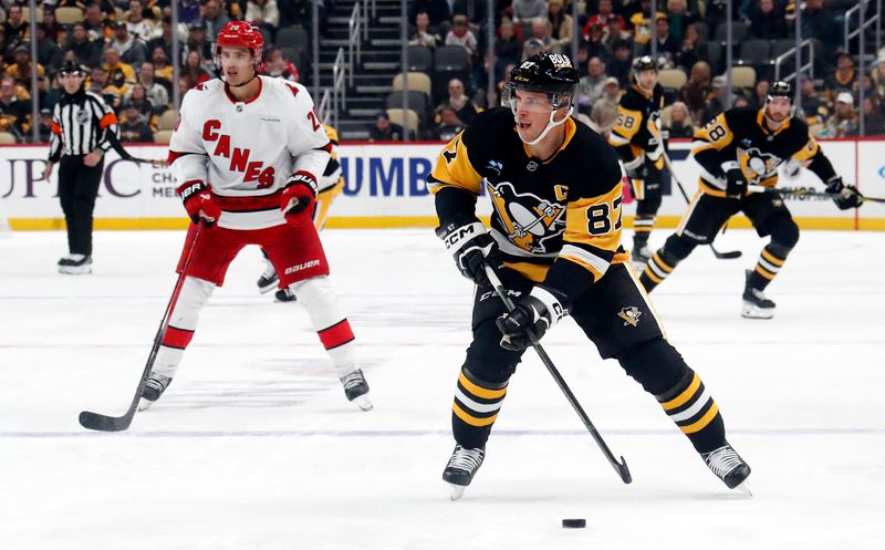 Oct 18, 2024; Pittsburgh, Pennsylvania, USA;  Pittsburgh Penguins center Sidney Crosby (87) skates up ice with the puck against the Carolina Hurricanes during the third period at PPG Paints Arena. Mandatory Credit: Charles LeClaire-Imagn Images