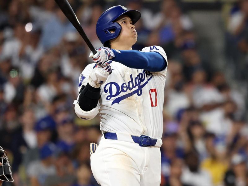 Jul 2, 2024; Los Angeles, California, USA;  Los Angeles Dodgers designated hitter Shohei Ohtani (17) hits a two-run home run during the seventh inning against the Arizona Diamondbacks at Dodger Stadium. Mandatory Credit: Kiyoshi Mio-USA TODAY Sports
