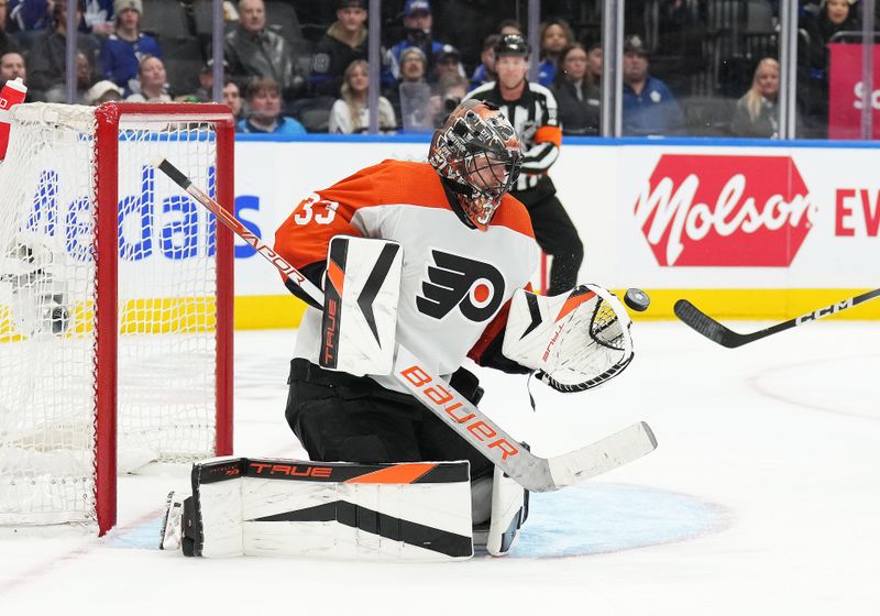 Feb 15, 2024; Toronto, Ontario, CAN; Philadelphia Flyers goaltender Samuel Ersson (33) makes a save against the Toronto Maple Leafs during the third period at Scotiabank Arena. Mandatory Credit: Nick Turchiaro-USA TODAY Sports