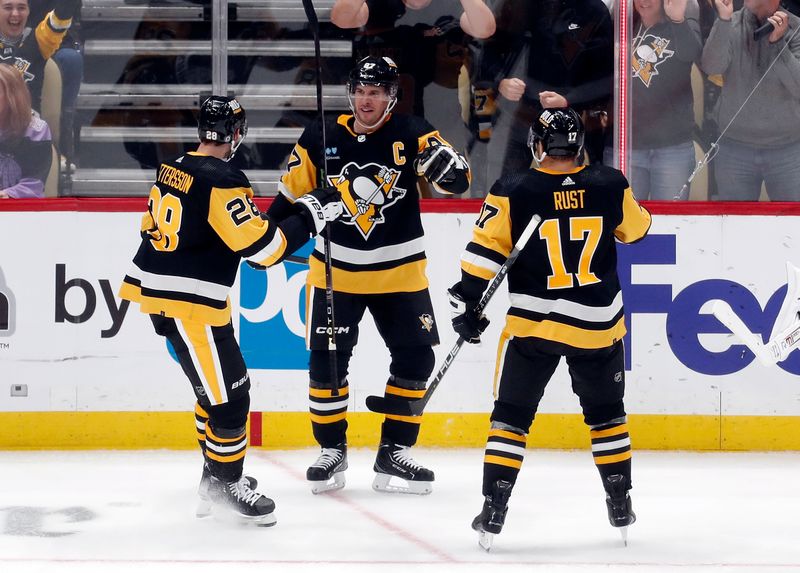 Oct 10, 2023; Pittsburgh, Pennsylvania, USA; Pittsburgh Penguins defenseman Marcus Pettersson (28) and right wing Bryan Rust (17) congratulate center Sidney Crosby (87) after Crosby scored a goal against the Chicago Blackhawks during the second period at the PPG Paints Arena. Mandatory Credit: Charles LeClaire-USA TODAY Sports