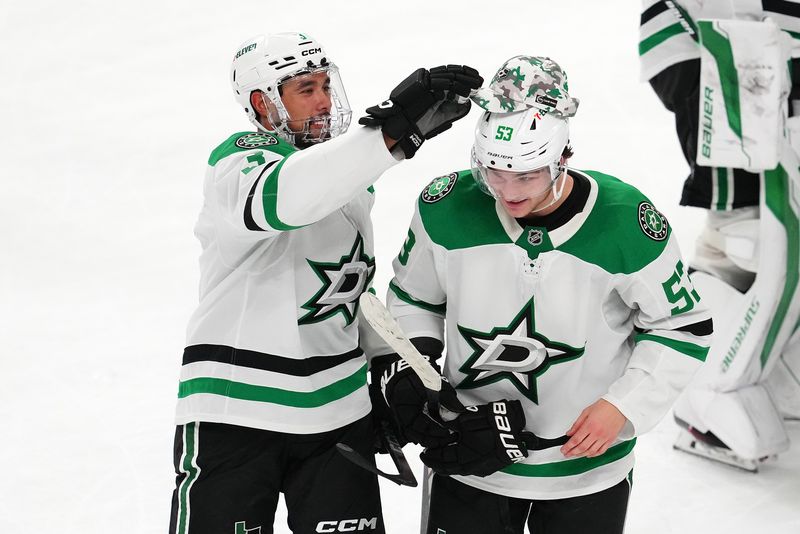 Jan 28, 2025; Las Vegas, Nevada, USA; Dallas Stars center Wyatt Johnston (53) gets a hat from Dallas Stars defenseman Mathew Dumba (3) after scoring a goal against the Vegas Golden Knights during an overtime period at T-Mobile Arena. Mandatory Credit: Stephen R. Sylvanie-Imagn Images