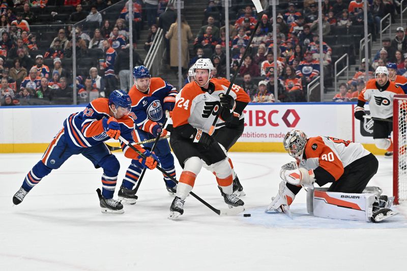 Jan 3, 2026; Edmonton, Alberta, CAN;   Edmonton Oilers center Ryan Nugent-Hopkins (93 tries to get the puck past Philadelphia Flyers defenseman Nick Seeler (24) in front of Flyers goalie Dan Vladar (80) during the first period at Rogers Place. Mandatory Credit: Walter Tychnowicz-Imagn Images