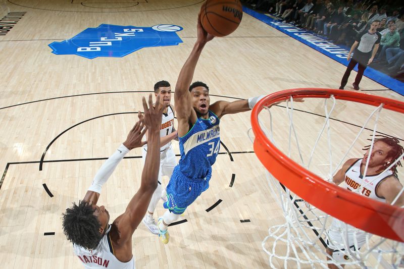 MILWAUKEE, WI - FEBRUARY 12: Giannis Antetokounmpo #34 of the Milwaukee Bucks dunks the ball during the game against the Denver Nuggets on February 12, 2024 at the Fiserv Forum Center in Milwaukee, Wisconsin. NOTE TO USER: User expressly acknowledges and agrees that, by downloading and or using this Photograph, user is consenting to the terms and conditions of the Getty Images License Agreement. Mandatory Copyright Notice: Copyright 2024 NBAE (Photo by Gary Dineen/NBAE via Getty Images).