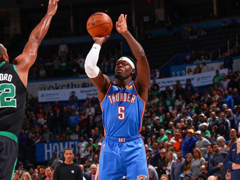 OKLAHOMA CITY, OK - JANUARY 3:  Luguentz Dort #5 of the Oklahoma City Thunder shoots a three point basket during the game against the Boston Celtics on January 3, 2023 at Paycom Arena in Oklahoma City, Oklahoma. NOTE TO USER: User expressly acknowledges and agrees that, by downloading and or using this photograph, User is consenting to the terms and conditions of the Getty Images License Agreement. Mandatory Copyright Notice: Copyright 2023 NBAE (Photo by Zach Beeker/NBAE via Getty Images)