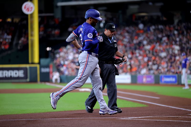 Jul 13, 2024; Houston, Texas, USA; Texas Rangers second baseman Marcus Semien (2) crosses home plate after hitting a home run against the Houston Astros during the first inning at Minute Maid Park. Mandatory Credit: Erik Williams-USA TODAY Sports